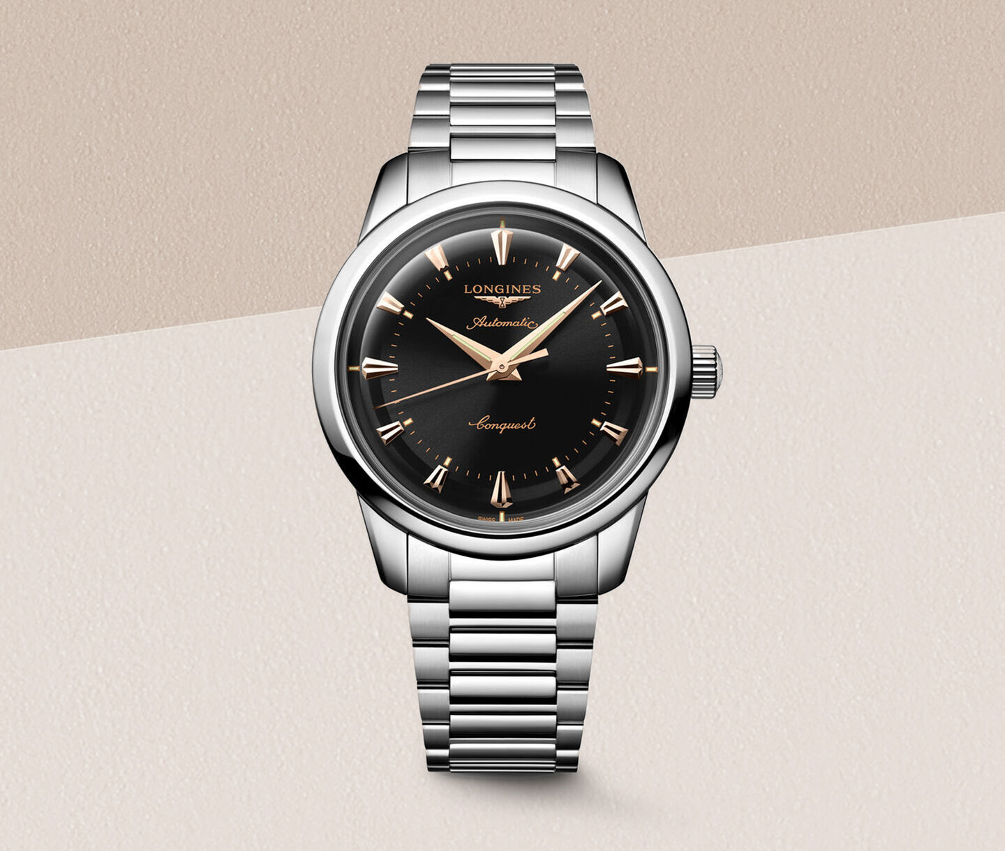 Longines Conquest Automatic watch on a beige background.